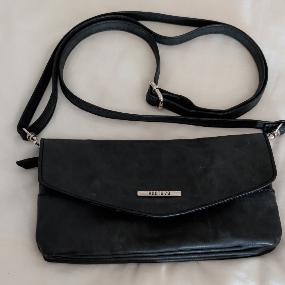 Roots Black Crossbody Clutch with Silver Logo